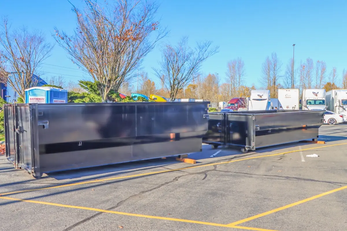 Professional dumpster rental service with roll-off container on residential driveway in Woods Cross